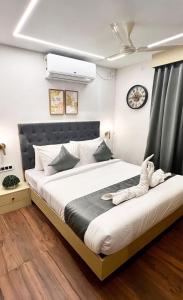1 dormitorio con 1 cama grande y reloj en la pared en Wild Wings Premium Hotel en Hyderabad