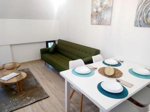 a living room with a white table and a green couch at VIVAL MINAS in Baeza +9 photos