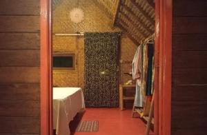 a room with a door leading to a room with a shower at UTOPIA BUNGALOWS in Gili Air