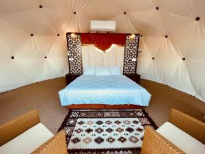 a bedroom with a bed in a tent at Hasan Zawaideh luxury camp 2 in Disah +120 photos