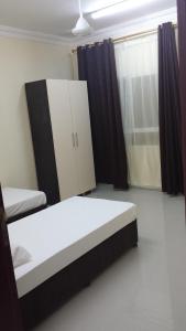 A bed or beds in a room at Golden Seasons Furnished Apartment