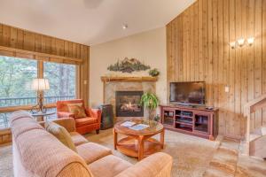 a living room with a couch and a fireplace at Ski House 245 in Bend