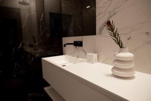 um vaso branco sentado num lavatório branco na casa de banho em Rentroom 1 em Polanica-Zdrój