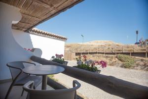 a balcony with a table and chairs and a view at Estalagem Muchaxo Hotel in Cascais