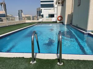 a swimming pool on the roof of a building at Elite LUX Holiday Homes - Fabulous Studio in Dubai Marina in Dubai