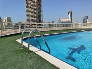 a swimming pool on the roof of a building at Elite LUX Holiday Homes - Fabulous Studio in Dubai Marina in Dubai