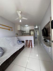 a living room with a bed and a kitchen at Ribeira Guest House in Angra dos Reis