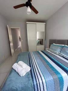 a bedroom with a bed with a ceiling fan at Ribeira Guest House in Angra dos Reis