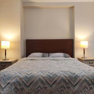a bedroom with a large bed with two lamps at MY Garden View in Antalya