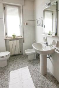 a bathroom with a sink and a toilet and a mirror at Hotel Le Vigne di Corvino in Casteggio
