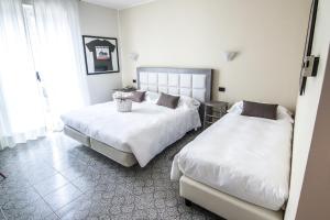 Postel nebo postele na pokoji v ubytování Hotel Le Vigne di Corvino