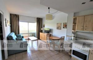 a kitchen and living room with a couch and a table at BENALBEACH 1010 - Vista al mar - Piscina todo el año - Primera linea de playa in Benalmádena