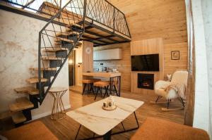 a living room with a spiral staircase and a kitchen at Sirius Lux Apartmani in Žabljak