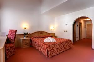 Postel nebo postele na pokoji v ubytování Hotel La Perla