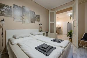 a bedroom with two beds with towels on them at RoomBack Rooms - 2BR Apt with AC near Deak ter in Budapest