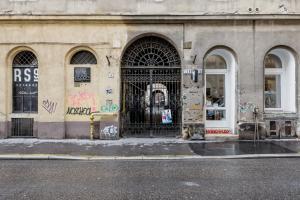 a building with a gate on the side of a street at RoomBack Rooms - 2BR Apt with AC near Deak ter in Budapest