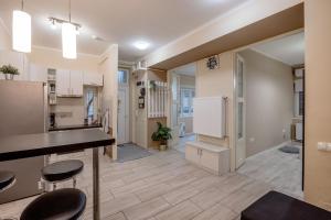 a kitchen with a counter and stools in a room at RoomBack Rooms - 2BR Apt with AC near Deak ter in Budapest