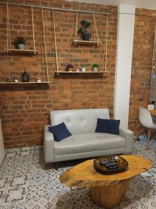 a living room with a couch and a coffee table at Samor centro histórico Bogota in Bogotá