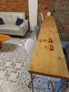 a wooden table with four chairs and a couch at Samor centro histórico Bogota in Bogotá