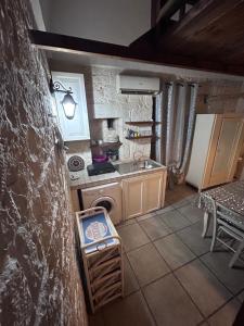 a small kitchen with a sink and a stove at La Casodda in Ostuni