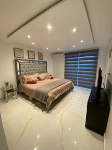 a bedroom with a bed and a large window at Marina del Sol Resort Condo directly on the Ocean 102 in Mazatlán +54 photos