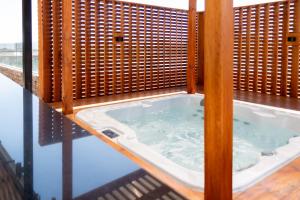 a jacuzzi tub on top of a balcony at Hotel HW High Wellness in Santiago