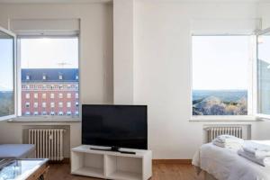 a living room with a flat screen tv and two windows at Madrid Executive Bright y Central in Madrid