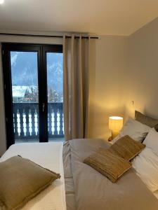 a bedroom with a bed and a large window at Appartement PISTE ROUGE in Les Houches