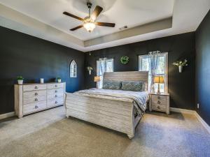 a bedroom with a bed and a ceiling fan at Spacious Columbus Getaway with Patio - Pets Welcome! in Columbus