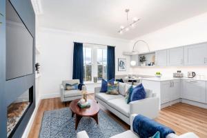 a living room with a couch and a table at Granby Gem: Exquisite 3-Bed Flat in Harrogate