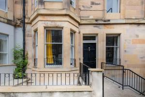 a building with a yellow curtain in the window at Colourful&Bright Apartment by Carlton Hill in Edinburgh