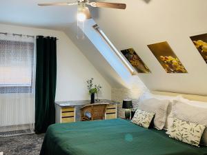 a bedroom with a bed and a ceiling fan at Hotel Marcincak*** in Mikulov +90 photos