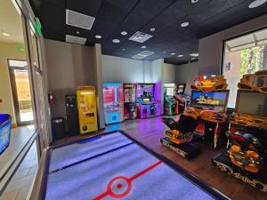 una sala con juegos de arcade y una bolera en Charming 4br/3.5bth Family Haven (15 Minutes to Disney), en Orlando