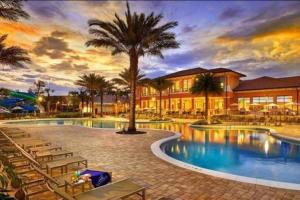 una piscina resort con sillas y una palmera en Charming 4br/3.5bth Family Haven (15 Minutes to Disney), en Orlando