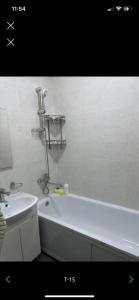 a bathroom with a white tub and a sink at Apartment Bishkek Kok-Dzhar district in Këk-Dzhar