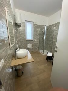 a bathroom with a sink and a shower at VILLA MANIVA in Ginosa Marina +93 photos