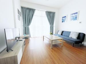 a living room with a blue couch and a table at Elite LUX Holiday Homes - One Bedroom Apartment in Silicon Oasis, Dubai in Dubai