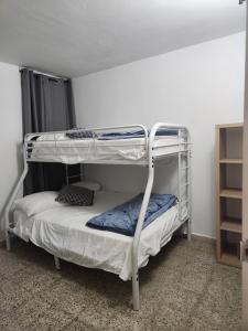 a bedroom with two bunk beds in a room at Beautiful Caribbean Waters - 7 Seas Beach, El Yunque, Icacos Island in Fajardo