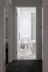 a white bathroom with a toilet and a sink at Host Liverpool - Cozy Home near Univ & Hospital,1mi to Station in Liverpool