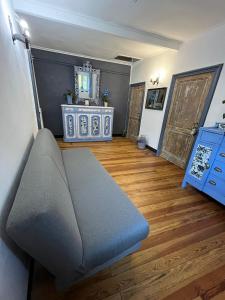 a living room with a couch and a wooden floor at LINO'S HOUSE in Sori