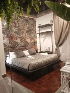 a bedroom with a bed with two rings on it at Plebiscito Suite Apartment in Naples