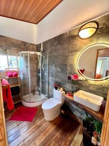 a bathroom with a shower and a toilet and a sink at Lemon House 2 in Las Palmeras