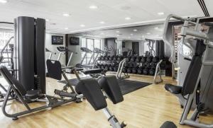 a gym with lots of treadmills and machines at Elite LUX Holiday Homes - Two Bedroom Apartment Direct Metro Access in Al Furjan, Dubai in Dubai