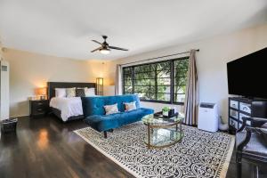 a living room with a blue couch and a bed at West Beach Villa 4 in Santa Barbara