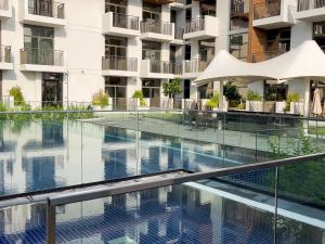 an empty swimming pool in an apartment building at Elite LUX Holiday Homes - Modern Studio in Arjan, Dubai in Dubai