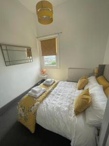 a bedroom with a large bed with pillows and a window at Castle Mount in Lincoln