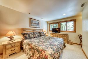 Un dormitorio con una cama y un televisor. en Dollar Meadows 1370, en Sun Valley