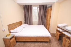a small bedroom with a bed and a window at Hotel 33 in Almaty