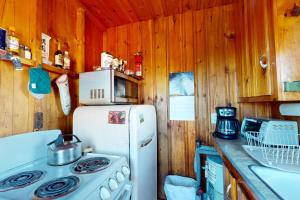 a kitchen with a white refrigerator and a microwave at Castine Cottages #6 in Castine