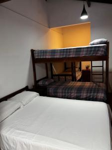 a bedroom with two bunk beds in a room at Nature Iguazu hostel B&B in Puerto Iguazú